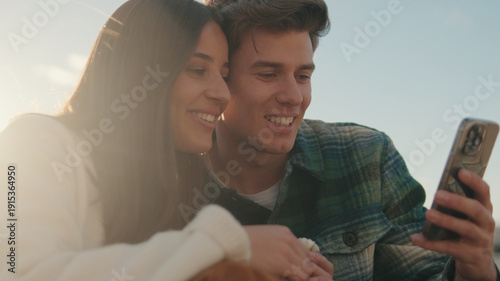 Wallpaper Mural Happy Couple Reading Phone Outdoors in Sevilla Torontodigital.ca