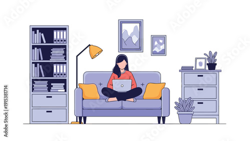 Productive woman works on her laptop while sitting comfortably on a sofa in a modern and organized home office.