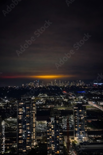 Wallpaper Mural Panoramic Night View of City Skyline with Glowing Orange Horizon and Illuminated Residential High-Rise Apartments Torontodigital.ca