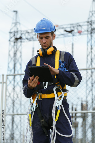 Canvas Print Electrical technicians are inspecting the operation and power distribution system within the substation that receives energy from the wind farm