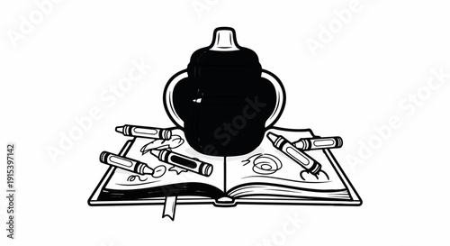 A black object sits atop an open book with crayons scattered around