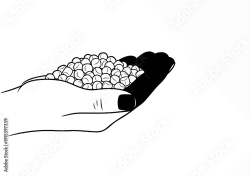 A hand holds a pile of small, round, light-colored objects