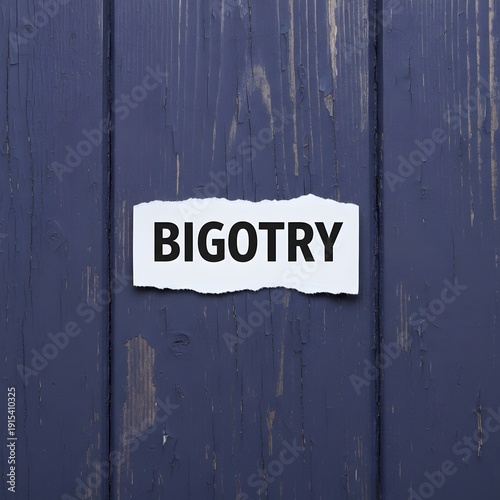 Torn piece of white paper with the word bigotry written in black bold letters