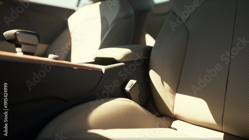 Sunlight streams into the cabin of a sleek car, highlighting the plush beige seats and smooth textures. The atmosphere suggests comfort and sophistication, perfect for any journey.