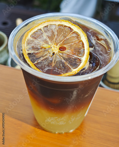 Refreshing Iced Yuzu Americano with Citrus Garnish in Glass