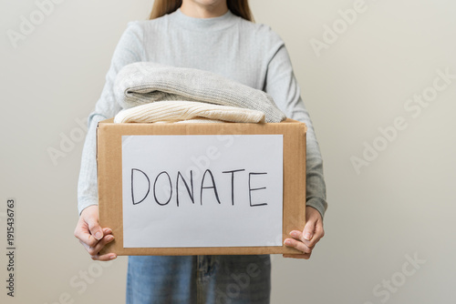 Photos Recycling, Donation for poor, asian young woman pack, hand in holding donate box full with second hand clothes, charity helping and needy people