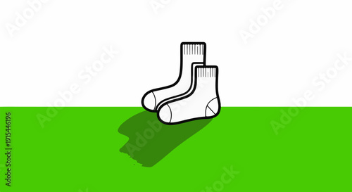 A pair of simple white socks with black outlines sits on a green surface