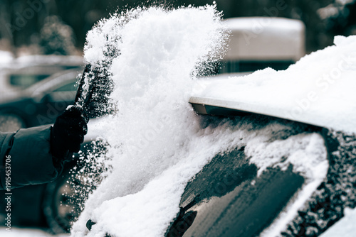 Scraping Ice and Snow from Car Windshield on a Cold Winter Morning