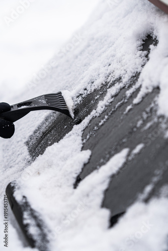 Scraping Ice and Snow from Car Windshield on a Cold Winter Morning