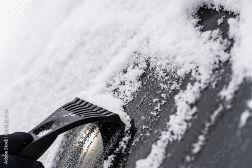 Scraping Ice and Snow from Car Windshield on a Cold Winter Morning