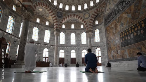 Men Praying in a Grand Mosque Interior.