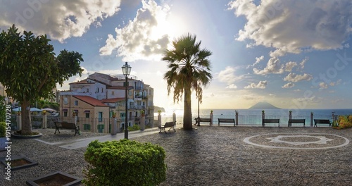 Belvedere Piazza del Cannone town square with the sun at its lowest and the Stromboli volcano in the sea in the distance, Tropea, Vibo Valentia, Calabria, Southern Italy, Italy