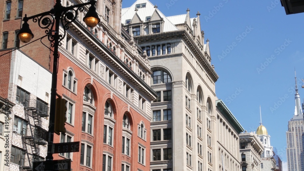 Obraz premium New York City Midtown urban buildings architecture, Manhattan street, 5 fifth avenue, United States of America. Red brick classic house, USA. Typical old historic real estate property in NYC. Lantern.