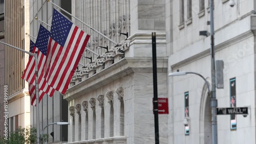 New York City Lower Manhattan Downtown Financial District, United States. Wall Street sign, stock exchange market building 1903, FiDi. American USA flag on facade. Trading finance and business concept