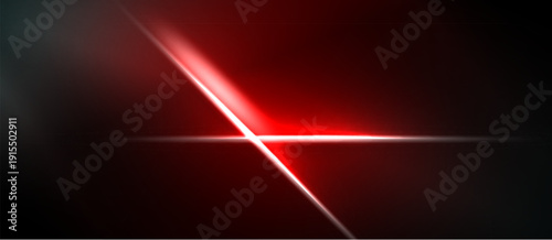 Abstract red light streaks cross dark background. Minimalist design creates dynamic visual impact. Brightness contrasts sharply with shadows.