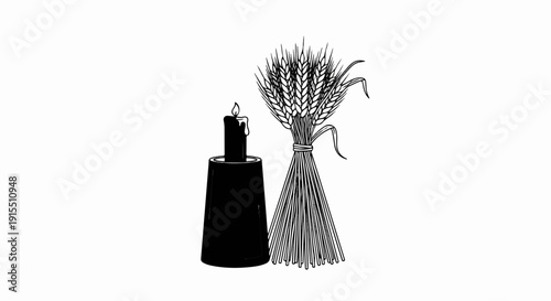 Black candle in holder next to a tied bundle of wheat stalks