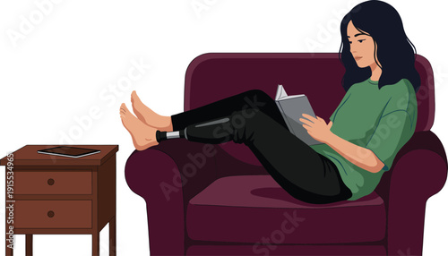 Young woman with prosthetic leg relaxing on comfortable purple armchair at home reading a book near wooden side table