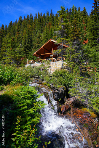 Картината върху платно Lake Agnes Tea House, a log cabin crowded with thirsty hikers located above Lake