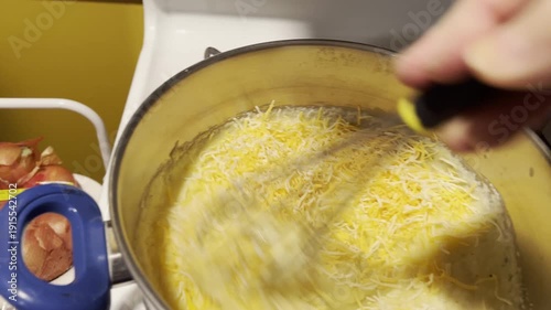 cooking creamy polenta with shredded cheese