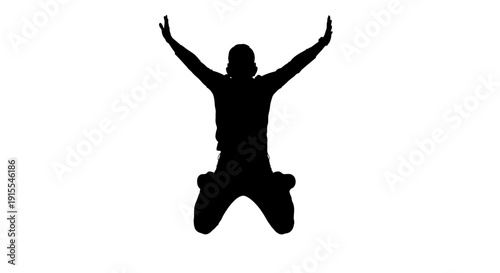 Silhouette of a person kneeling with arms raised in worship or praise.