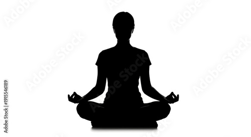 Silhouette of a person meditating in a lotus pose.