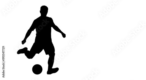 Silhouette of a soccer player kicking a ball.