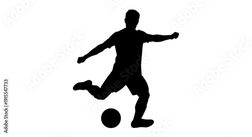 Silhouette of a Soccer Player Kicking a Ball in Action.