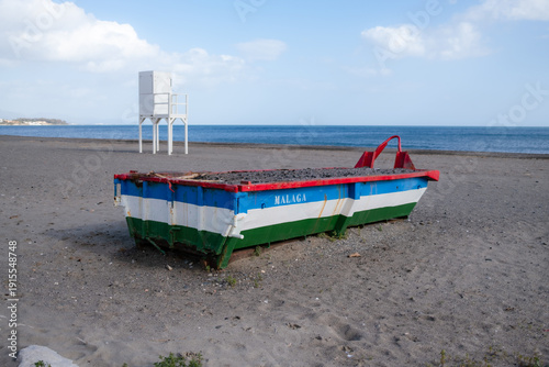 Colorful fishing boat on Malaga beach, Spain. Mediterranean seascape with copy space