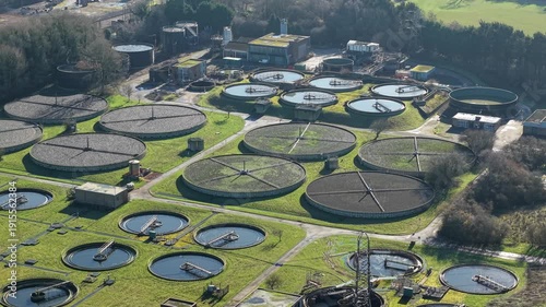 Wallpaper Mural Aerial overview of a major UK sewage facility, emphasizing the intricate network of sedimentation ponds and clarifiers in a rural setting. Torontodigital.ca