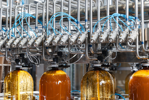 Fotografie Modern beer factory automation with bottling machinery and tubing systems to pla