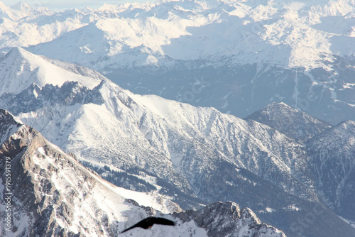 Panoramic view of the snowcovered alps in bavaria europe germany under a blue sky from german mountain Zugspitze