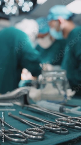 Surgical instruments in the operating room during operation. Professional healthcare teamwork. Vertical shot