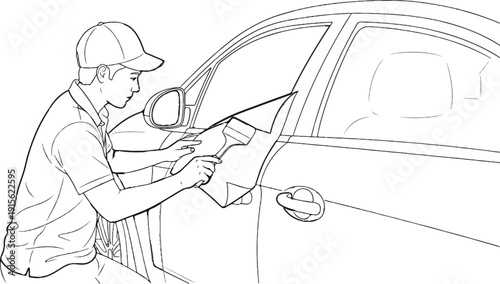 Man applying tint film to car window with squeegee tool