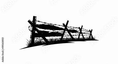 Silhouette of a barbed wire fence with sharp wooden posts and grass