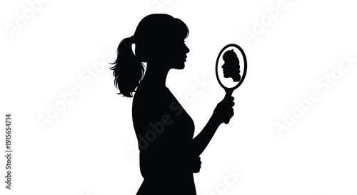 Woman viewing her reflection in a hand mirror a striking silhouette