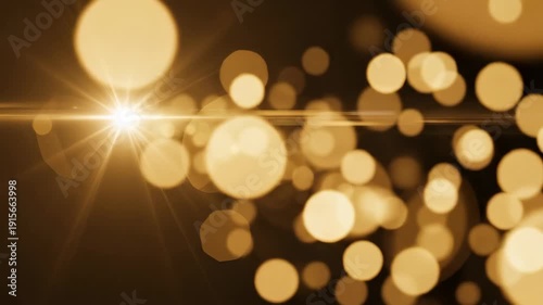 Golden light burst with lens flares on dark background