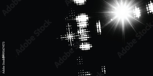 A bright, star-like light source bursts across a dark background with digital-like reflections.