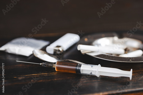 Tableau sur toile Concept of substance abuse and drug addiction, syringe with dose, ashtray with c