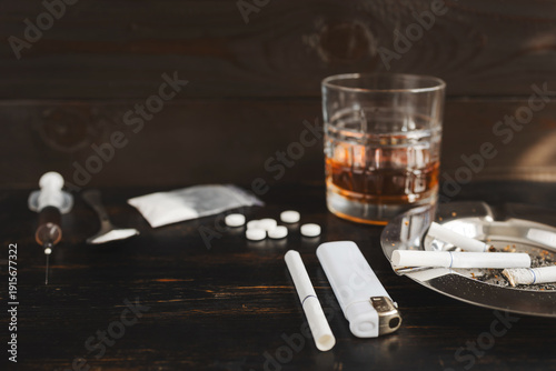 Obraz na plátně Concept of substance abuse and drug addiction, glass of alcohol, ashtray with ci