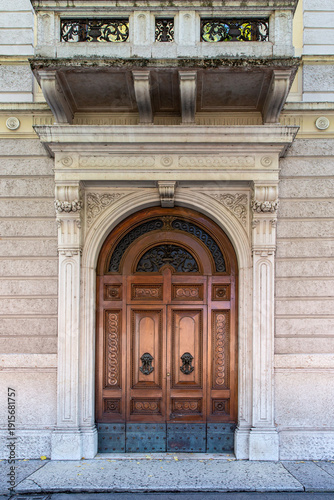 Ornate wooden door and historic facade in Verona, Italy