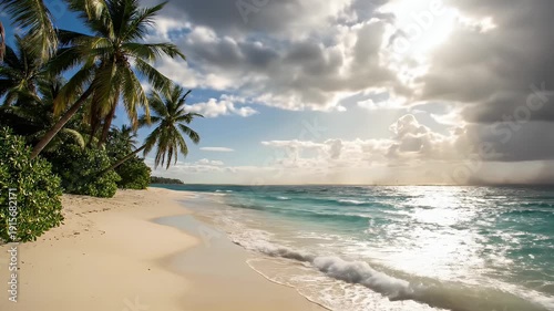 Tropical beach with dramatic stormy clouds and sunbeams over turquoise waves