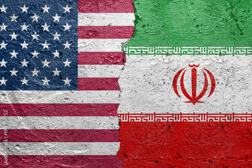 United States of America vs Iran - Cracked concrete wall painted with a USA flag on the left and a Iranian flag on the right stock photo