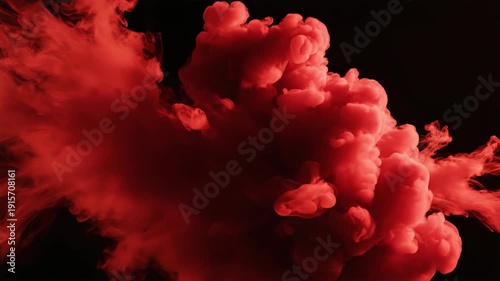 vibrant red ink explosion creating artistic splatter patterns against dark background for creative design inspiration and visual effects