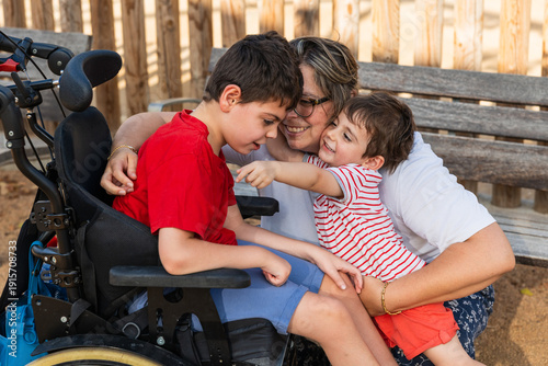 Photos Family hugging disabled son in wheelchair with brother