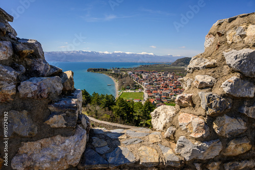 Принти на полотні Framed by rugged stone walls of Samuel's Fortress, the charming Ohrid town stretches to the blue Lake Ohrid and majestic snow-capped mountains beyond