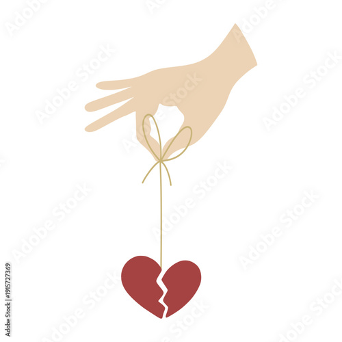 Hand holding broken heart by string