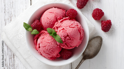 Raspberry ice cream in white bowl overhead shot