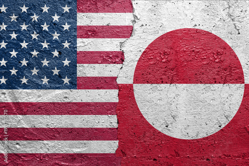 United States of America vs Greenland - Cracked concrete wall painted with a USA flag on the left and a Greenland flag on the right stock photo