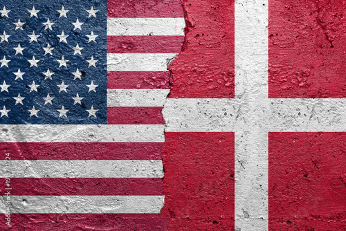United States of America vs Greenland - Cracked concrete wall painted with a USA flag on the left and a Greenland flag on the right stock photo