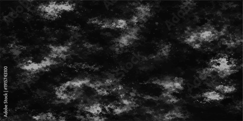 Abstract black and white cloudscape featuring a dark storm atmosphere with bright light breaking through a moody grey sky